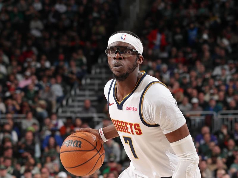 MILWAUKEE, WI - FEBRUARY 12: Reggie Jackson #7 of the Denver Nuggets handles the ball during the game against the Milwaukee Bucks on February 12, 2024 at the Fiserv Forum Center in Milwaukee, Wisconsin. NOTE TO USER: User expressly acknowledges and agrees that, by downloading and or using this Photograph, user is consenting to the terms and conditions of the Getty Images License Agreement. Mandatory Copyright Notice: Copyright 2024 NBAE (Photo by Gary Dineen/NBAE via Getty Images).