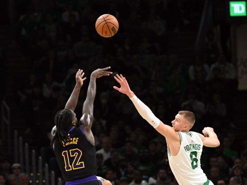 BOSTON, MASSACHUSETTS - FEBRUARY 01: Taurean Prince #12 of the Los Angeles Lakers attempts a basket against Kristaps Porzingis #8 of the Boston Celtics during the fourth quarter at the TD Garden on February 01, 2024 in Boston, Massachusetts. NOTE TO USER: User expressly acknowledges and agrees that, by downloading and or using this photograph, User is consenting to the terms and conditions of the Getty Images License Agreement. (Photo by Brian Fluharty/Getty Images)