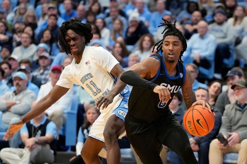 Jan 7, 2025; Chapel Hill, North Carolina, USA; Southern Methodist Mustangs guard B.J. Edwards (0) passes the ball as North Carolina Tar Heels guard Ian Jackson (11) defends in the first half at Dean E. Smith Center. Mandatory Credit: Bob Donnan-Imagn Images