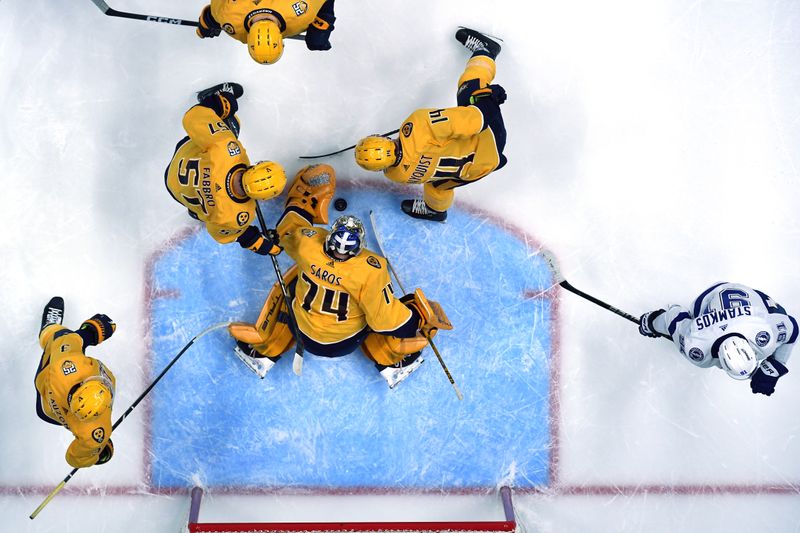 Dec 7, 2023; Nashville, Tennessee, USA; Nashville Predators goaltender Juuse Saros (74) makes a save during the first period against the Tampa Bay Lightning at Bridgestone Arena. Mandatory Credit: Christopher Hanewinckel-USA TODAY Sports