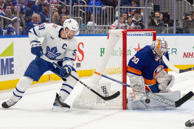 Dec 11, 2023; Elmont, New York, USA; Toronto Maple Leafs center John Tavares (91) takes a shot while New York Islanders goaltender Ilya Sorokin (30) makes the save during the third period at UBS Arena. Mandatory Credit: Thomas Salus-USA TODAY Sports