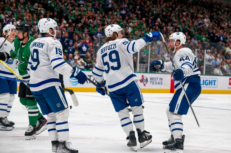 Oct 26, 2023; Dallas, Texas, USA; Toronto Maple Leafs center Calle Jarnkrok (19) and left wing Tyler Bertuzzi (59) and defenseman Morgan Rielly (44) celebrates a goal scored by Bertuzzi against the Dallas Stars during the third period at the American Airlines Center. Mandatory Credit: Jerome Miron-USA TODAY Sports