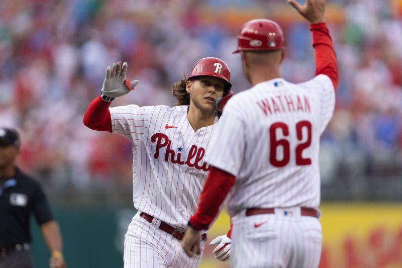 Aug 5, 2023; Philadelphia, Pennsylvania, USA; Philadelphia Phillies first baseman Alec Bohm (28) high fives third base coach Dusty Wathan (62) after hitting a two RBI home run during the first inning against the Kansas City Royals at Citizens Bank Park. Mandatory Credit: Bill Streicher-USA TODAY Sports