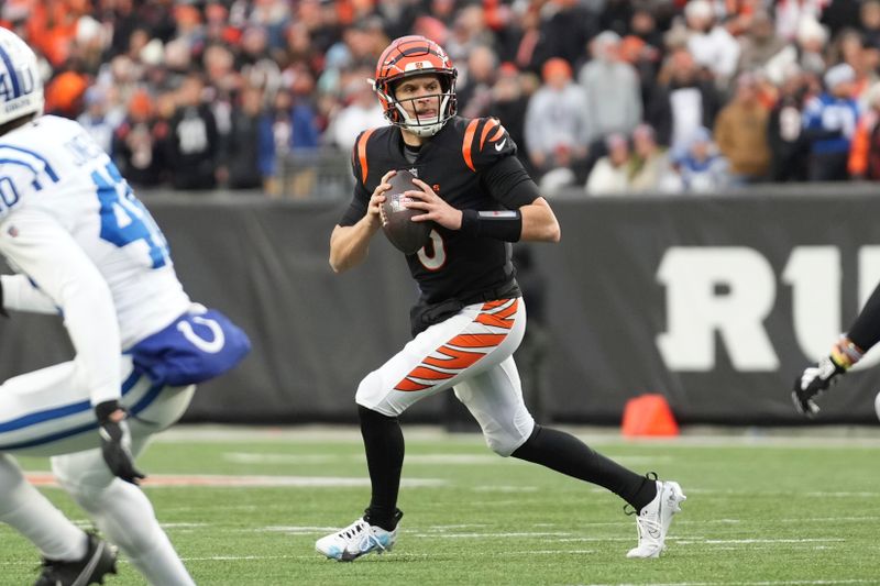 Cincinnati Bengals quarterback Jake Browning (6) looks for an open receiver downfield as he rolls out in the backfield during an NFL football game against the Indianapolis Colts, Sunday, Dec. 10, 2023, in Cincinnati, OH. (AP Photo/Peter Joneleit)