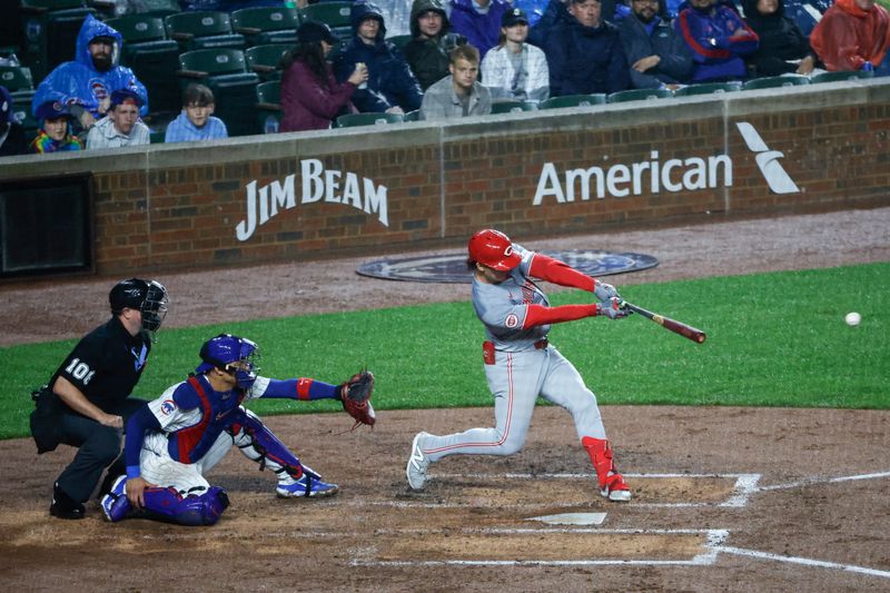 Jun 1, 2024; Chicago, Illinois, USA; Cincinnati Reds outfielder Stuart Fairchild (17) hits an RBI-single against the Chicago Cubs during the second inning at Wrigley Field. Mandatory Credit: Kamil Krzaczynski-USA TODAY Sports