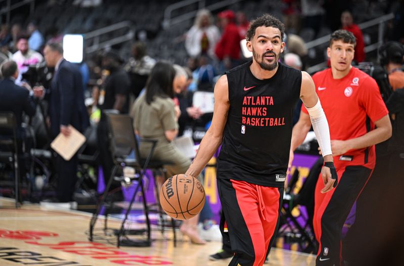 ATLANTA, GEORGIA - APRIL 10: Trae Young #11 of the Atlanta Hawks warms up before the game against the Charlotte Hornets at State Farm Arena on April 10, 2024 in Atlanta, Georgia. NOTE TO USER: User expressly acknowledges and agrees that, by downloading and/or using this photograph, user is consenting to the terms and conditions of the Getty Images License Agreement. (Photo by Paras Griffin/Getty Images)