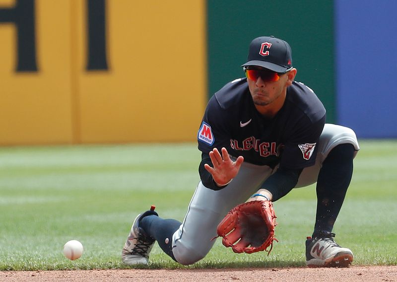 Jul 19, 2023; Pittsburgh, Pennsylvania, USA;  Cleveland Guardians second baseman Andres Gimenez (0) fields a ground ball for an out against Pittsburgh Pirates center fielder Jack Suwinski (not pictured)) during the third inning at PNC Park. Mandatory Credit: Charles LeClaire-USA TODAY Sports