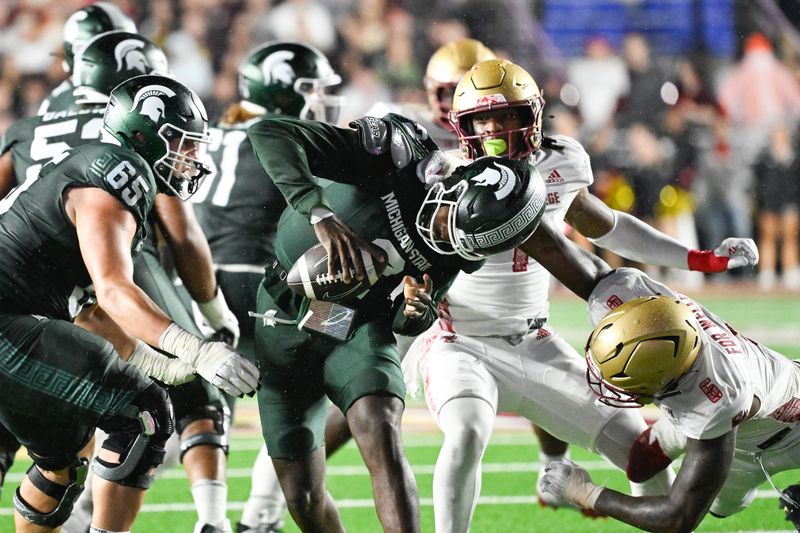 Sep 21, 2024; Chestnut Hill, Massachusetts, USA; Michigan State Spartans quarterback Aidan Chiles (2) is sacked by Boston College Eagles defensive end Donovan Ezeiruaku (6) during the second half at Alumni Stadium. Mandatory Credit: Eric Canha-Imagn Images