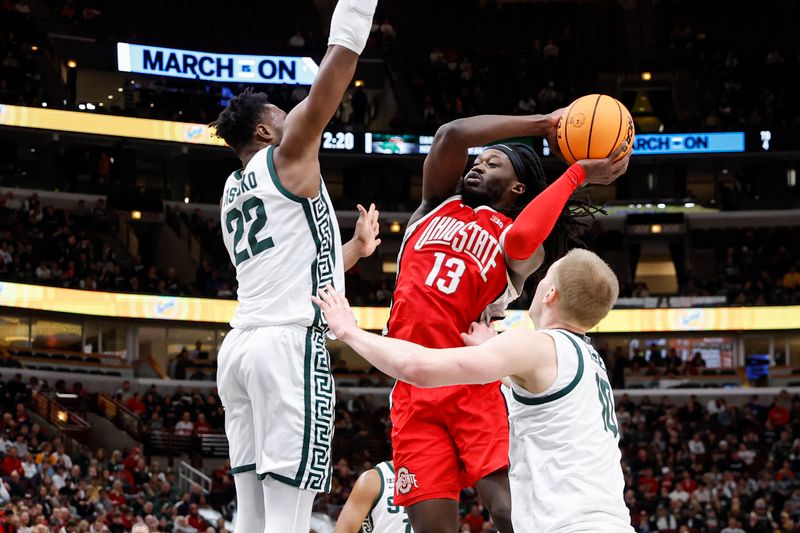 Mar 10, 2023; Chicago, IL, USA; Ohio State Buckeyes guard Isaac Likekele (13) goes to the basket against Michigan State Spartans center Mady Sissoko (22) during the first half at United Center. Mandatory Credit: Kamil Krzaczynski-USA TODAY Sports