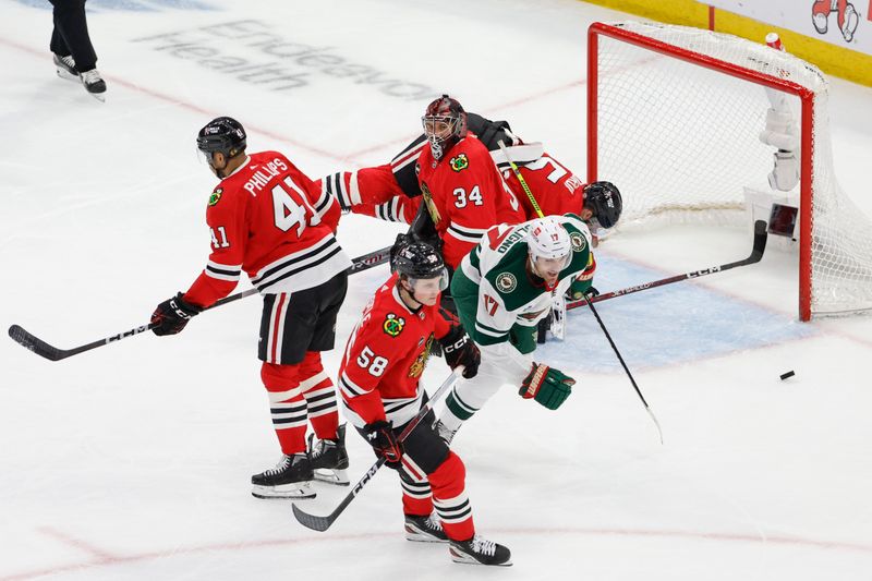 Feb 7, 2024; Chicago, Illinois, USA; Minnesota Wild left wing Marcus Foligno (17) celebrates after scoring against Chicago Blackhawks goaltender Petr Mrazek (34) during the third period at United Center. Mandatory Credit: Kamil Krzaczynski-USA TODAY Sports