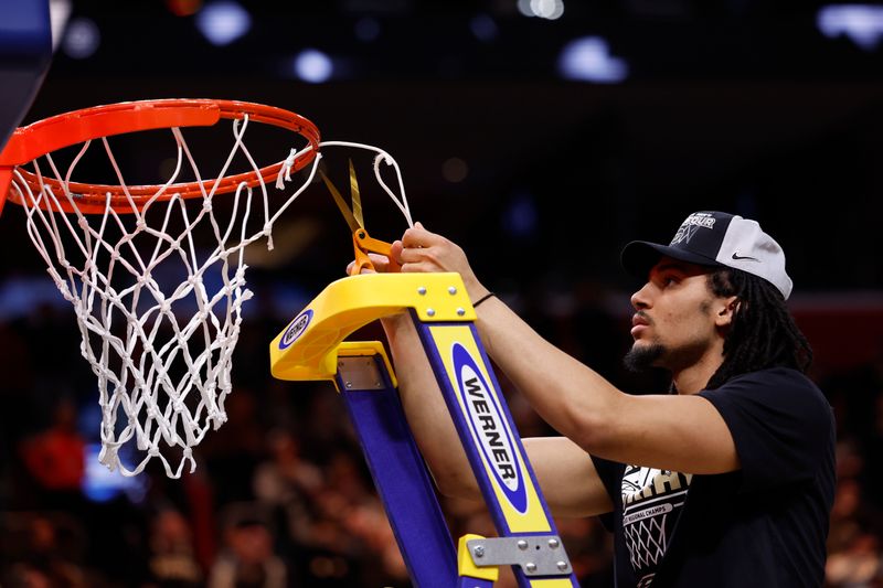 Mar 31, 2024; Detroit, MI, USA; Purdue Boilermakers forward Trey Kaufman-Renn (4) cuts down the net after defeating the Tennessee Volunteers during the NCAA Tournament Midwest Regional Championship at Little Caesars Arena. Mandatory Credit: Rick Osentoski-USA TODAY Sports