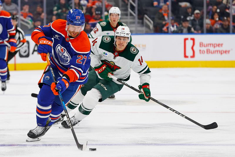 Nov 21, 2024; Edmonton, Alberta, CAN; Edmonton Oilers defensemen Brett Kulak (27) looks to make a pass in front of Minnesota Wild forward Joel Ericksson EK (14) during the second period at Rogers Place. Mandatory Credit: Perry Nelson-Imagn Images