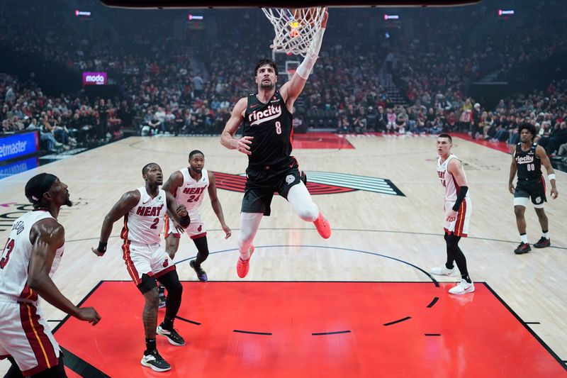 PORTLAND, OREGON - JANUARY 11: Deni Avdija #8 of the Portland Trail Blazers dunks the ball during the first half against the Miami Heat at Moda Center on January 11, 2025 in Portland, Oregon. NOTE TO USER: User expressly acknowledges and agrees that, by downloading and or using this photograph, User is consenting to the terms and conditions of the Getty Images License Agreement. (Photo by Soobum Im/Getty Images)