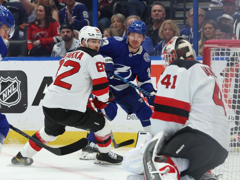 Jan 27, 2024; Tampa, Florida, USA; Tampa Bay Lightning center Michael Eyssimont (23) as New Jersey Devils goaltender Vitek Vanecek (41) defends during the first period at Amalie Arena. Mandatory Credit: Kim Klement Neitzel-USA TODAY Sports