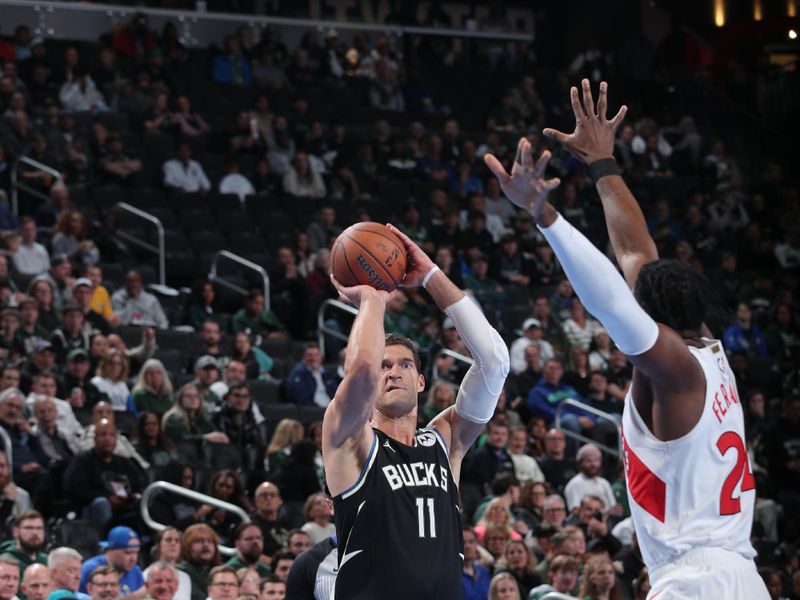 MILWAUKEE, WI - NOVEMBER 12: Brook Lopez #11 of the Milwaukee Bucks shoots the ball during the game against the Toronto Raptors  during the Emirates NBA Cup game on November 12, 2024 at Fiserv Forum Center in Milwaukee, Wisconsin. NOTE TO USER: User expressly acknowledges and agrees that, by downloading and or using this Photograph, user is consenting to the terms and conditions of the Getty Images License Agreement. Mandatory Copyright Notice: Copyright 2024 NBAE (Photo by Gary Dineen/NBAE via Getty Images).