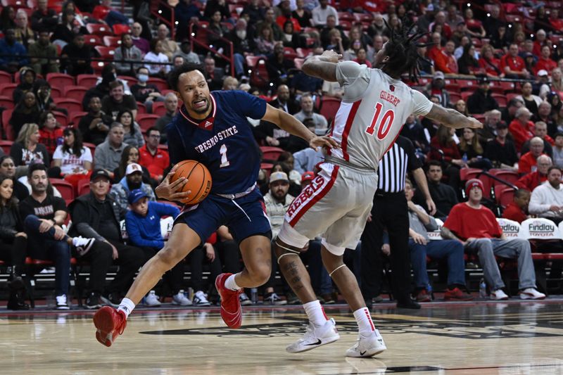 Feb 3, 2023; Las Vegas, Nevada, USA; Fresno State Bulldogs guard Jermarl Baker (1) drives past UNLV Runnin' Rebels guard Keshon Gilbert (10) in the second half at Thomas & Mack Center. Mandatory Credit: Candice Ward-USA TODAY Sports