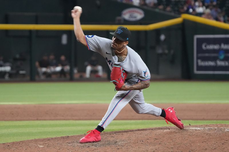 Jun 29, 2025; Phoenix, Arizona, USA; Miami Marlins pitcher Ronny Henriquez (32) pitches against the Arizona Diamondbacks during the ninth inning at Chase Field. Mandatory Credit: Joe Camporeale-Imagn Images