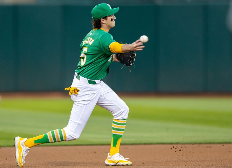 Sep 20, 2024; Oakland, California, USA; Oakland Athletics shortstop Jacob Wilson (5) turns a double play during the first inning against the New York Yankees at Oakland-Alameda County Coliseum. Mandatory Credit: Bob Kupbens-Imagn Images