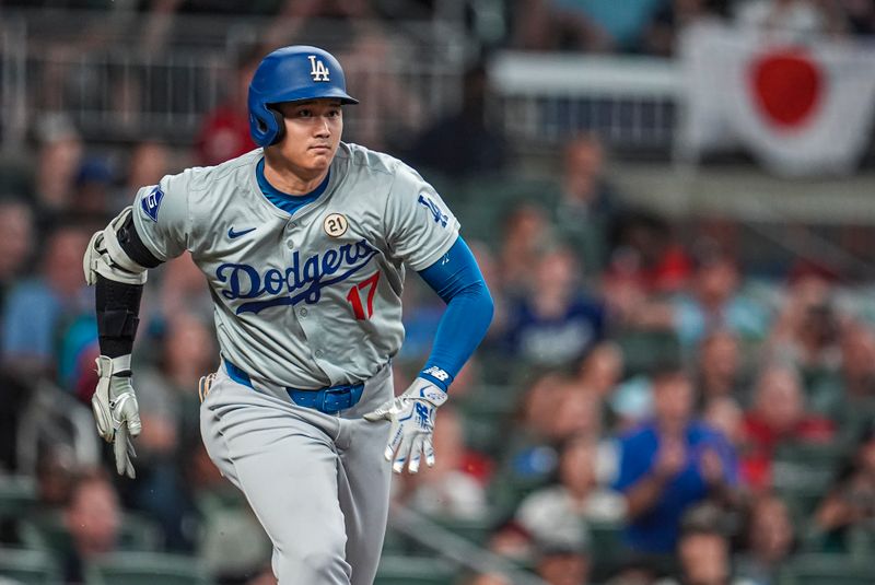 Sep 15, 2024; Cumberland, Georgia, USA; Los Angeles Dodgers designated hitter Shohei Ohtani (17) runs after hitting a double to drive in a run against the Atlanta Braves during the fifth inning at Truist Park. Mandatory Credit: Dale Zanine-Imagn Images