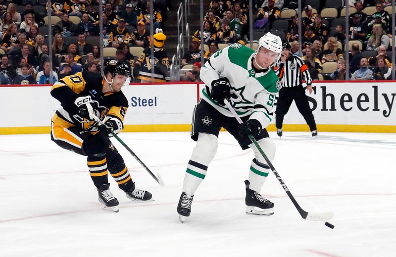 Oct 24, 2023; Pittsburgh, Pennsylvania, USA; Dallas Stars defenseman Thomas Harley (55) clears the puck against Pittsburgh Penguins center Lars Eller (20) during the third period at PPG Paints Arena. Dallas won 4-1. Mandatory Credit: Charles LeClaire-USA TODAY Sports