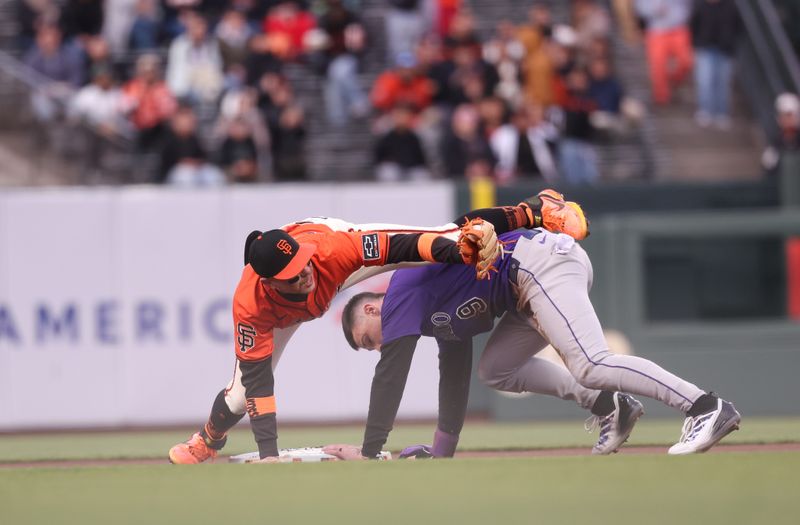 May 2, 2025; San Francisco, California, USA;  San Francisco Giants second baseman Christian Koss (50) catches Colorado Rockies center fielder Brenton Doyle (9) trying to steal second base during the first inning at Oracle Park. Mandatory Credit: Kelley L Cox-Imagn Images