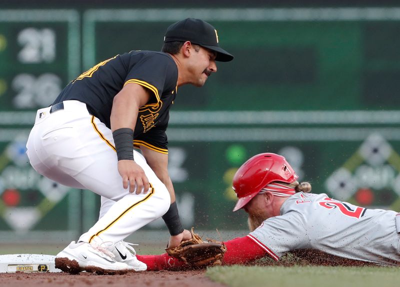 Jun 18, 2024; Pittsburgh, Pennsylvania, USA;  Pittsburgh Pirates second baseman Nick Gonzales (39) tags Cincinnati Reds right fielder Jake Fraley (27) out at second base on a steal attempt during the third inning at PNC Park. Mandatory Credit: Charles LeClaire-USA TODAY Sports