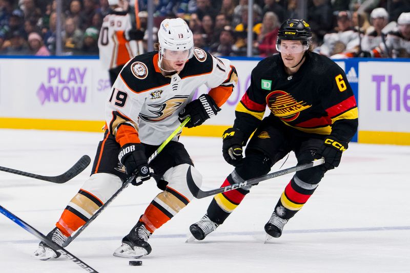 Nov 28, 2023; Vancouver, British Columbia, CAN; Anaheim Ducks forward Troy Terry (19) drives past Vancouver Canucks forward Brock Boeser (6) in the third period at Rogers Arena. Vancouver won 3-1. Mandatory Credit: Bob Frid-USA TODAY Sports