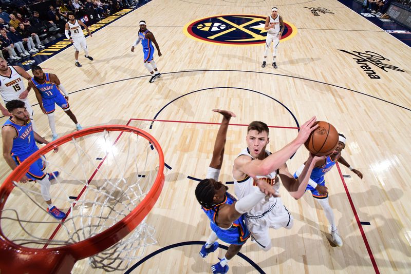 DENVER, CO - OCTOBER 24: Christian Braun #0 of the Denver Nuggets drives to the basket during the game against the Oklahoma City Thunder on October 24, 2024 at Ball Arena in Denver, Colorado. NOTE TO USER: User expressly acknowledges and agrees that, by downloading and/or using this Photograph, user is consenting to the terms and conditions of the Getty Images License Agreement. Mandatory Copyright Notice: Copyright 2024 NBAE (Photo by Garrett Ellwood/NBAE via Getty Images)