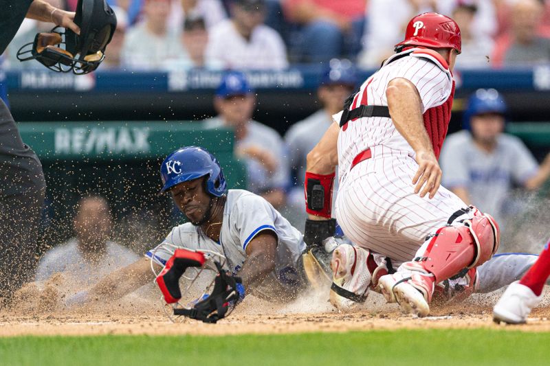 Aug 5, 2023; Philadelphia, Pennsylvania, USA; Kansas City Royals second baseman Samad Taylor (0) slides past the tag attempt of Philadelphia Phillies catcher J.T. Realmuto (10) on a squeeze play during the fifth inning at Citizens Bank Park. Mandatory Credit: Bill Streicher-USA TODAY Sports