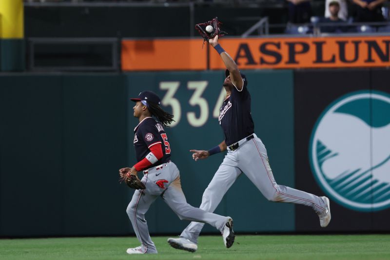Apr 30, 2025; Philadelphia, Pennsylvania, USA; Washington Nationals outfielder James Wood (29) catches a pop up alongside shortstop CJ Abrams (5) for an out against the Philadelphia Phillies during the seventh inning at Citizens Bank Park. Mandatory Credit: Bill Streicher-Imagn Images