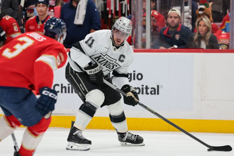 Dec 17, 2025; Sunrise, Florida, USA; Los Angeles Kings center Anze Kopitar (11) moves the puck against the Florida Panthers during the first period at Amerant Bank Arena. Mandatory Credit: Sam Navarro-Imagn Images