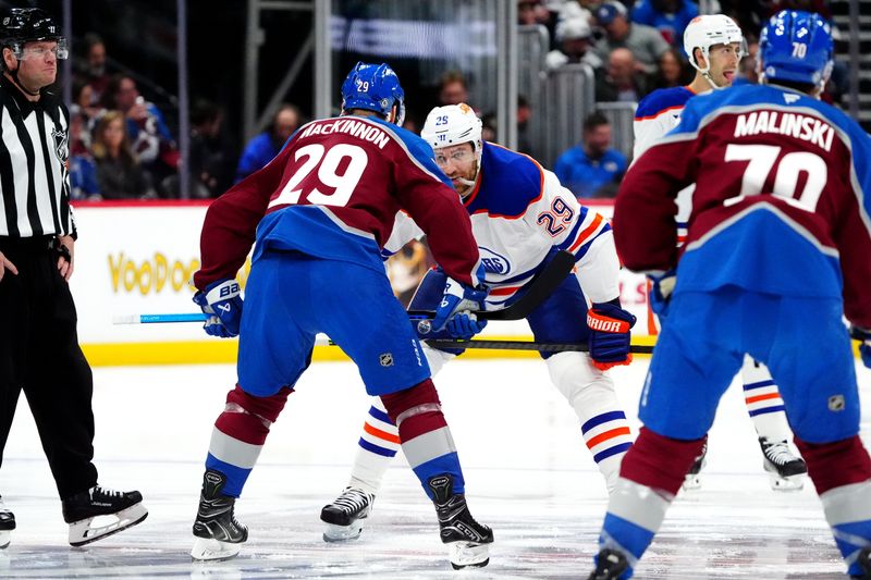 Nov 30, 2024; Denver, Colorado, USA; Edmonton Oilers center Leon Draisaitl (29) and Colorado Avalanche center Nathan MacKinnon (29) prepare to face off in the first period at Ball Arena. Mandatory Credit: Ron Chenoy-Imagn Images