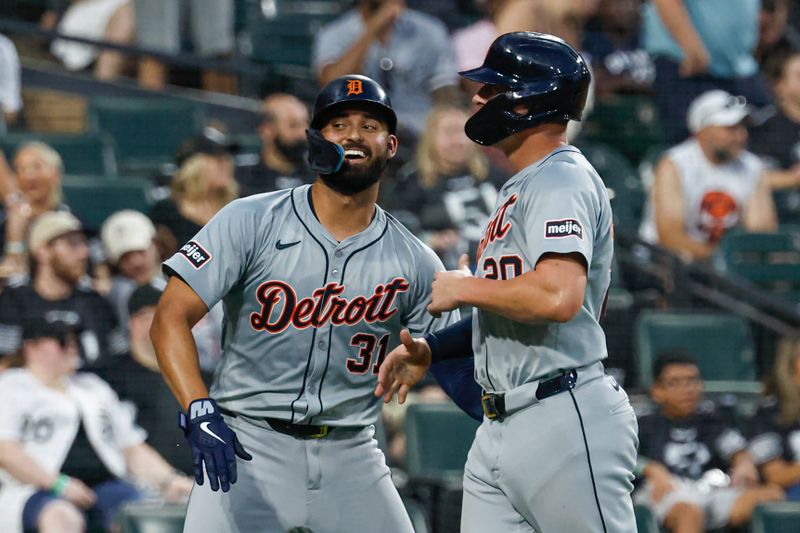 Aug 24, 2024; Chicago, Illinois, USA; Detroit Tigers first baseman Spencer Torkelson (20) celebrates with outfielder Riley Greene (31) after they both scored against the Chicago White Sox during the fourth inning at Guaranteed Rate Field. Mandatory Credit: Kamil Krzaczynski-USA TODAY Sports