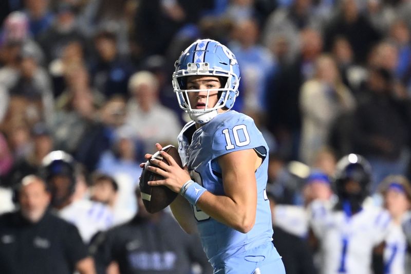 Nov 11, 2023; Chapel Hill, North Carolina, USA; DUPLICATE***North Carolina Tar Heels quarterback Drake Maye (10)***North Carolina Tar Heels defensive lineman Desmond Evans (10) looks to pass in the second quarter at Kenan Memorial Stadium. Mandatory Credit: Bob Donnan-USA TODAY Sports