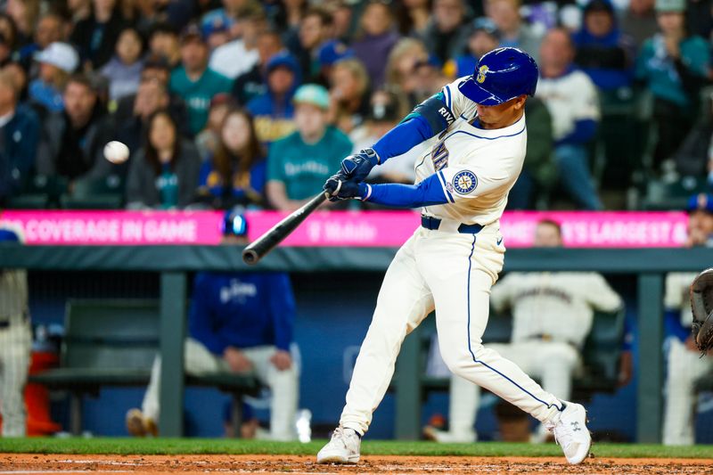 Apr 28, 2024; Seattle, Washington, USA; Seattle Mariners shortstop Leo Rivas (76) hits a triple against the Arizona Diamondbacks during the third inning at T-Mobile Park. The play was the first major league hit for Rivas. Mandatory Credit: Joe Nicholson-USA TODAY Sports