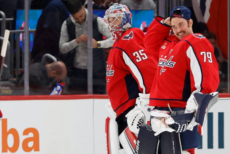 Feb 26, 2024; Washington, District of Columbia, USA; Washington Capitals goaltender Darcy Kuemper (35) celebrates with Capitals goaltender Charlie Lindgren (79) after their game against the Ottawa Senators at Capital One Arena. Mandatory Credit: Geoff Burke-USA TODAY Sports