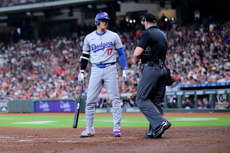 Jul 28, 2024; Houston, Texas, USA; Los Angeles Dodgers designated hitter Shohei Ohtani (17) talks with home plate umpire Brennan Miller (55) against the Houston Astros during the fifth inning at Minute Maid Park. Mandatory Credit: Erik Williams-USA TODAY Sports