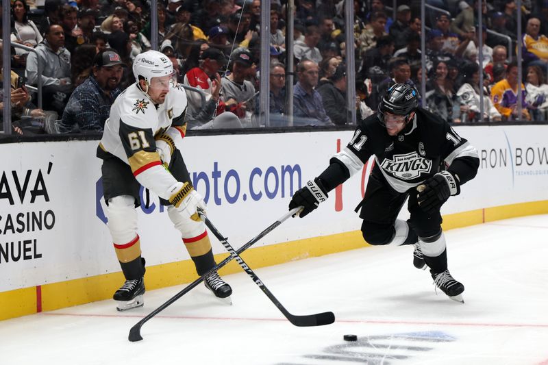 Oct 30, 2024; Los Angeles, California, USA;  Los Angeles Kings center Anze Kopitar (11) fights for the puck against Vegas Golden Knights right wing Mark Stone (61) during the third period at Crypto.com Arena. Mandatory Credit: Kiyoshi Mio-Imagn Images