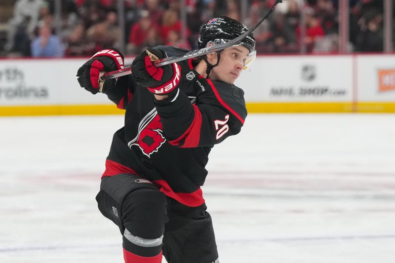 Feb 26, 2026; Raleigh, North Carolina, USA;  Carolina Hurricanes center Sebastian Aho (20) scores a goal on his shot against the Tampa Bay Lightning during the third period at Lenovo Center. Mandatory Credit: James Guillory-Imagn Images