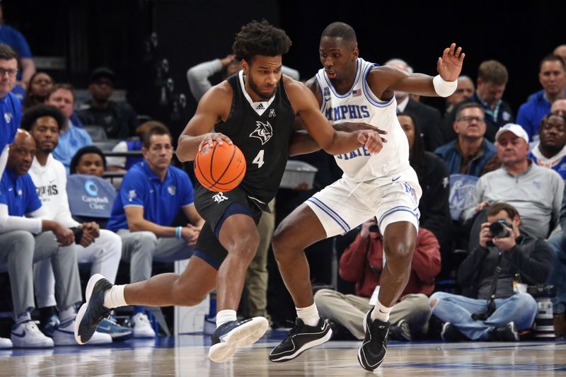 Jan 31, 2024; Memphis, Tennessee, USA; Rice Owls guard Anthony Selden (4) defends as Memphis Tigers forward David Jones (8) defends during the first half at FedExForum. Mandatory Credit: Petre Thomas-USA TODAY Sports