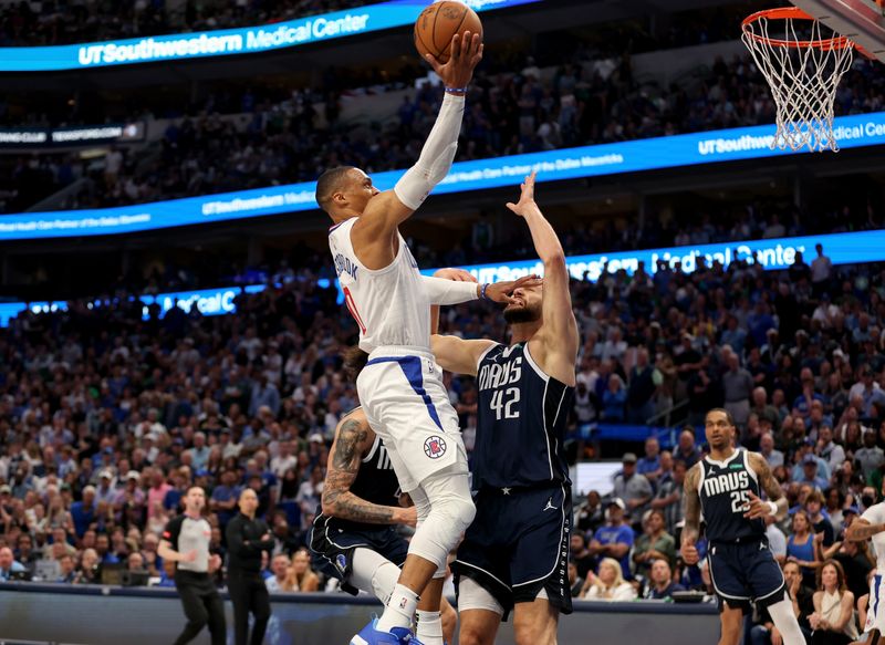 DALLAS, TEXAS - APRIL 28: Russell Westbrook #0 of the Los Angeles Clippers goes up for a lay up while defended by Maxi Kleber #42 of the Dallas Mavericks in the second half of game four of the Western Conference First Round Playoffs at American Airlines Center on April 28, 2024 in Dallas, Texas.  NOTE TO USER: User expressly acknowledges and agrees that, by downloading and or using this photograph, User is consenting to the terms and conditions of the Getty Images License Agreement. (Photo by Tim Warner/Getty Images)