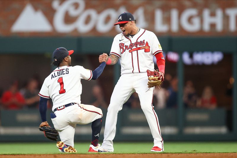 Jun 27, 2023; Atlanta, Georgia, USA; Atlanta Braves second baseman Ozzie Albies (1) and shortstop Orlando Arcia (11) react after an out against the Minnesota Twins in the fifth inning at Truist Park. Mandatory Credit: Brett Davis-USA TODAY Sports