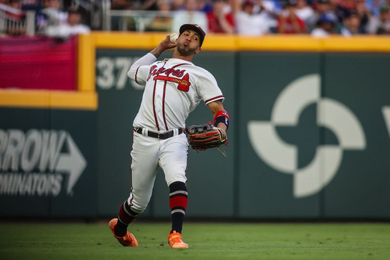 Jun 27, 2023; Atlanta, Georgia, USA; Atlanta Braves left fielder Eddie Rosario (8) throws home against the Minnesota Twins in the fourth inning at Truist Park. Mandatory Credit: Brett Davis-USA TODAY Sports