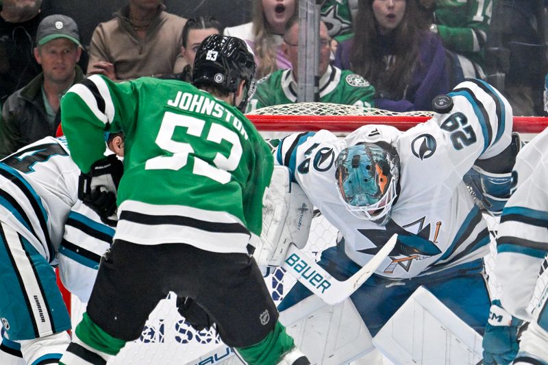 Nov 20, 2024; Dallas, Texas, USA; San Jose Sharks goaltender Mackenzie Blackwood (29) keeps the puck out of the net on a shot by Dallas Stars center Wyatt Johnston (53) during the third period at the American Airlines Center. Mandatory Credit: Jerome Miron-Imagn Images