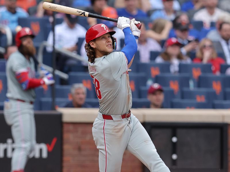 May 14, 2024; New York City, New York, USA; Philadelphia Phillies third baseman Alec Bohm (28) follows through on an RBI ground-rule double during the ninth inning against the New York Mets at Citi Field. Mandatory Credit: Brad Penner-USA TODAY Sports