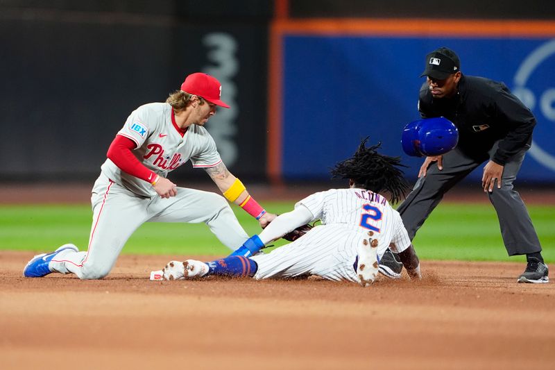 Sep 22, 2024; New York City, New York, USA; New York Mets shortstop Luisangel Acuna (2) is tagged out by Philadelphia Phillies second baseman Bryson Stott (5) attempting to steal second base during the fifth inning at Citi Field. Mandatory Credit: Gregory Fisher-Imagn Images