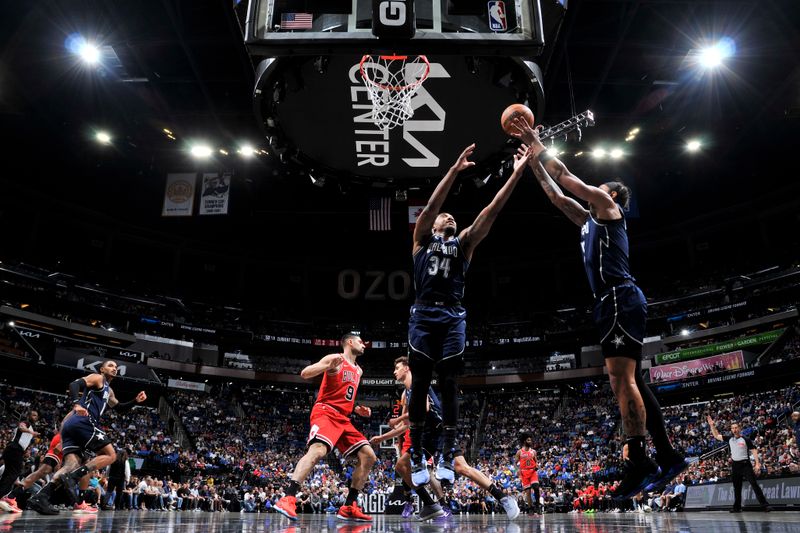 ORLANDO, FL - APRIL 7: Wendell Carter Jr. #34 and Paolo Banchero #5 of the Orlando Magic go up for the rebound during the game against the Chicago Bulls on April 7, 2024 at the Kia Center in Orlando, Florida. NOTE TO USER: User expressly acknowledges and agrees that, by downloading and or using this photograph, User is consenting to the terms and conditions of the Getty Images License Agreement. Mandatory Copyright Notice: Copyright 2024 NBAE (Photo by Fernando Medina/NBAE via Getty Images)