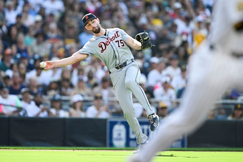 Sep 2, 2024; San Diego, California, USA; Detroit Tigers relief pitcher Brenan Hanifee (75) throws to first base but can’t get the out on San Diego Padres third baseman Donovan Solano (not pictured) during the third inning at Petco Park. Mandatory Credit: Denis Poroy-USA TODAY Sports