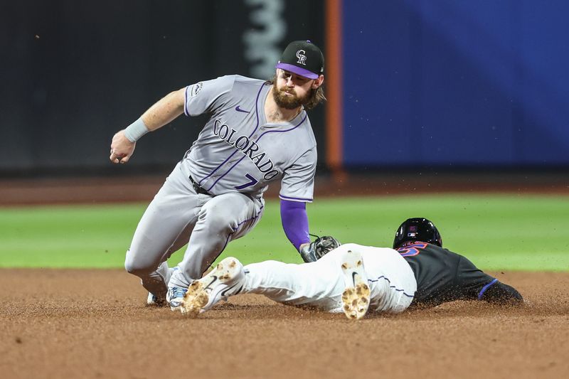 Jul 12, 2024; New York City, New York, USA;  Colorado Rockies second baseman Brendan Rodgers (7) tags out New York Mets pinch runner Tyrone Taylor (15) attempting to steal in the seventh inning at Citi Field. Mandatory Credit: Wendell Cruz-USA TODAY Sports