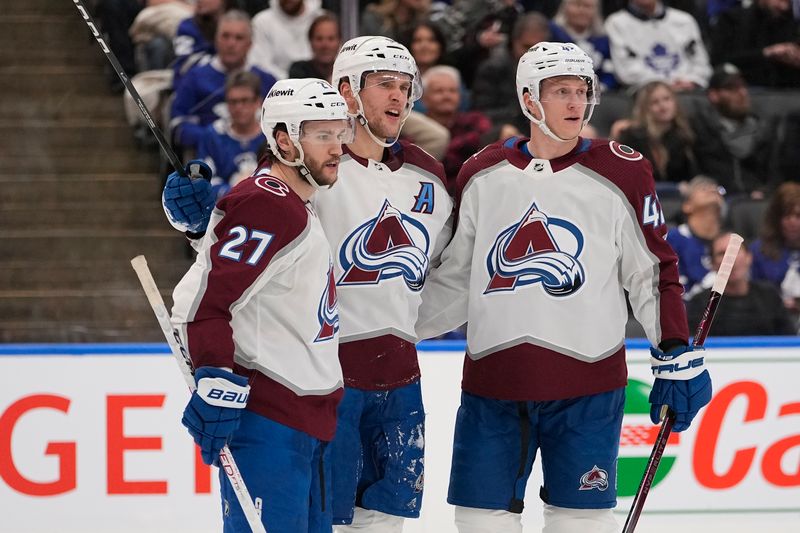 Jan 13, 2024; Toronto, Ontario, CAN; Colorado Avalanche forward Mikko Rantanen (96) celebrates his goal against the Toronto Maple Leafs with Colorado Avalanche forward Jonathan Drouin (27) and defenseman Josh Manson (42) during the second period at Scotiabank Arena. Mandatory Credit: John E. Sokolowski-USA TODAY Sports